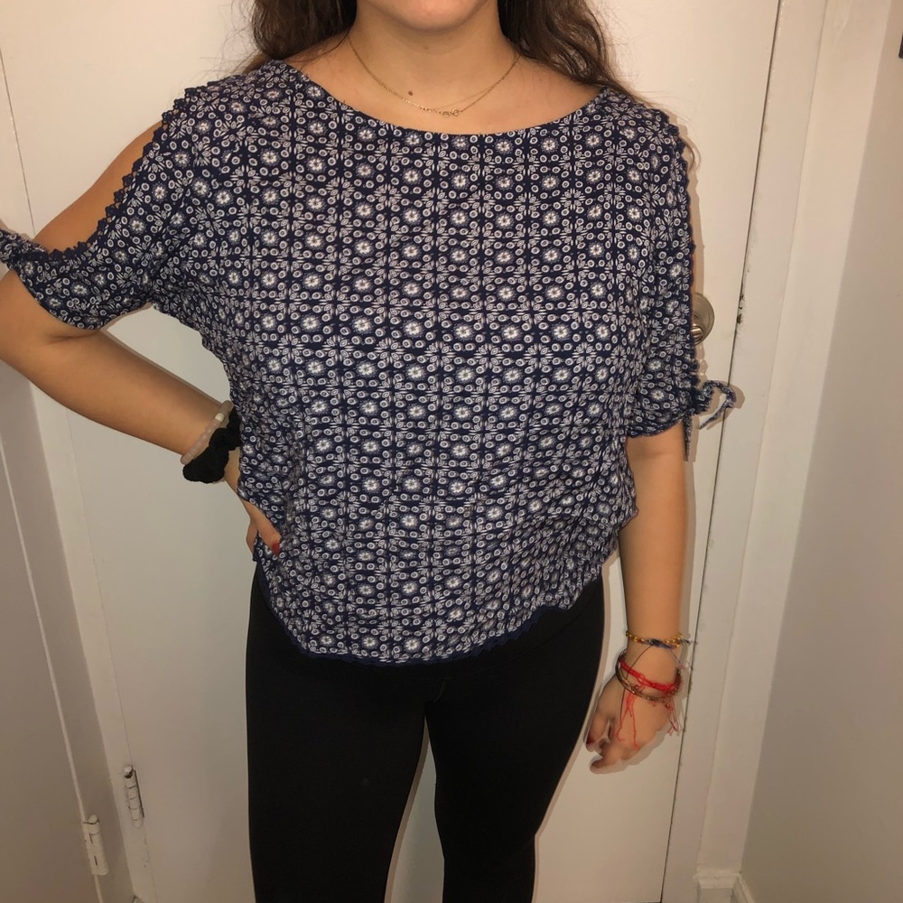 Blue patterned blouse.